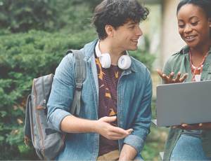 Two people smiling at a laptop