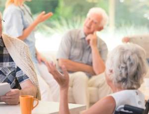 Care home residents having a conversation in a communal space