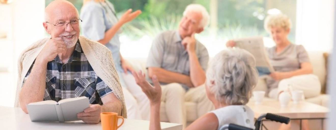 Care home residents having a conversation in a communal space