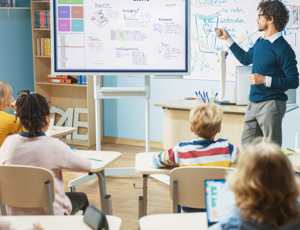 A teacher in a classroom in front of students