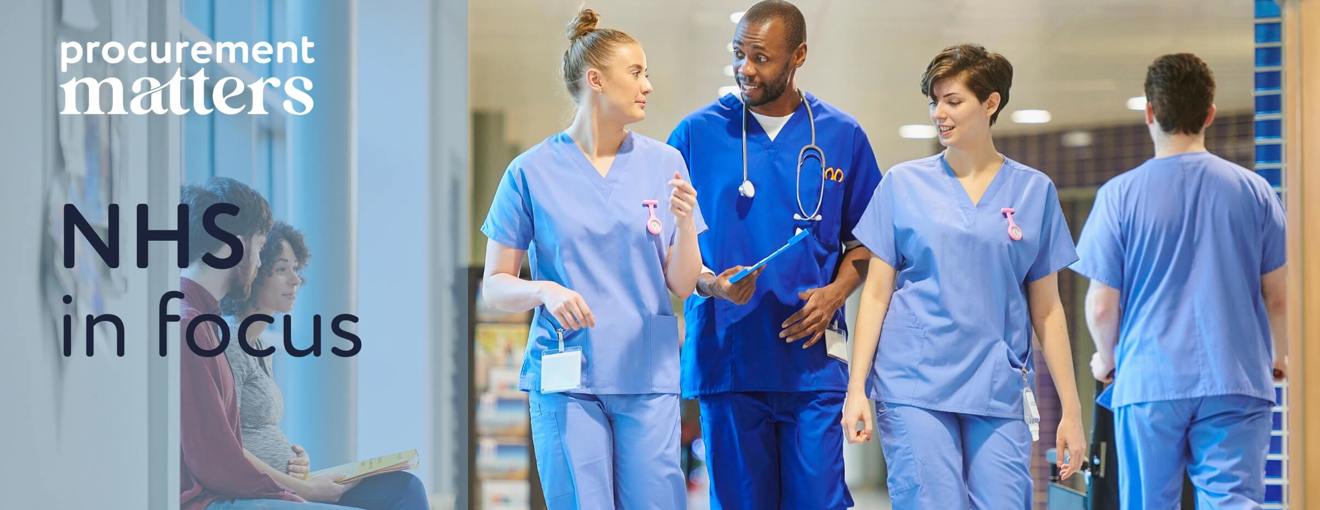 Healthcare staff walking through a hospital corridor wearing medical scrubs
